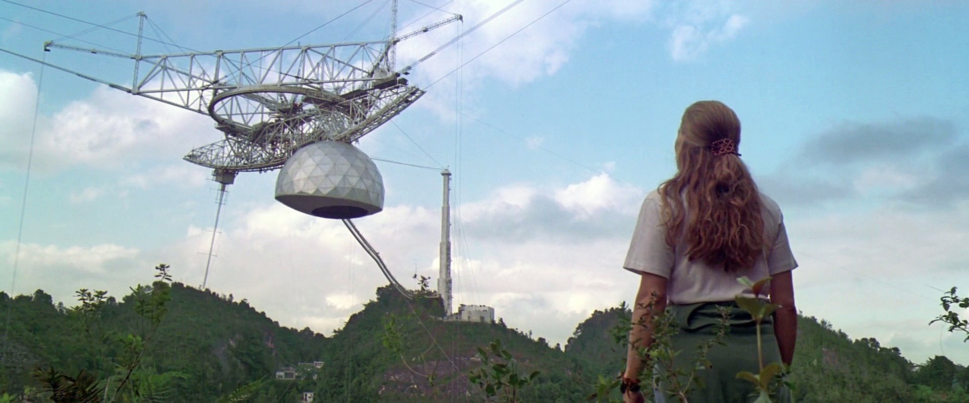 A screenshot from the movie Contact (1997), showing Jodie Foster staring up at Arecibo's Gregorian dome.
