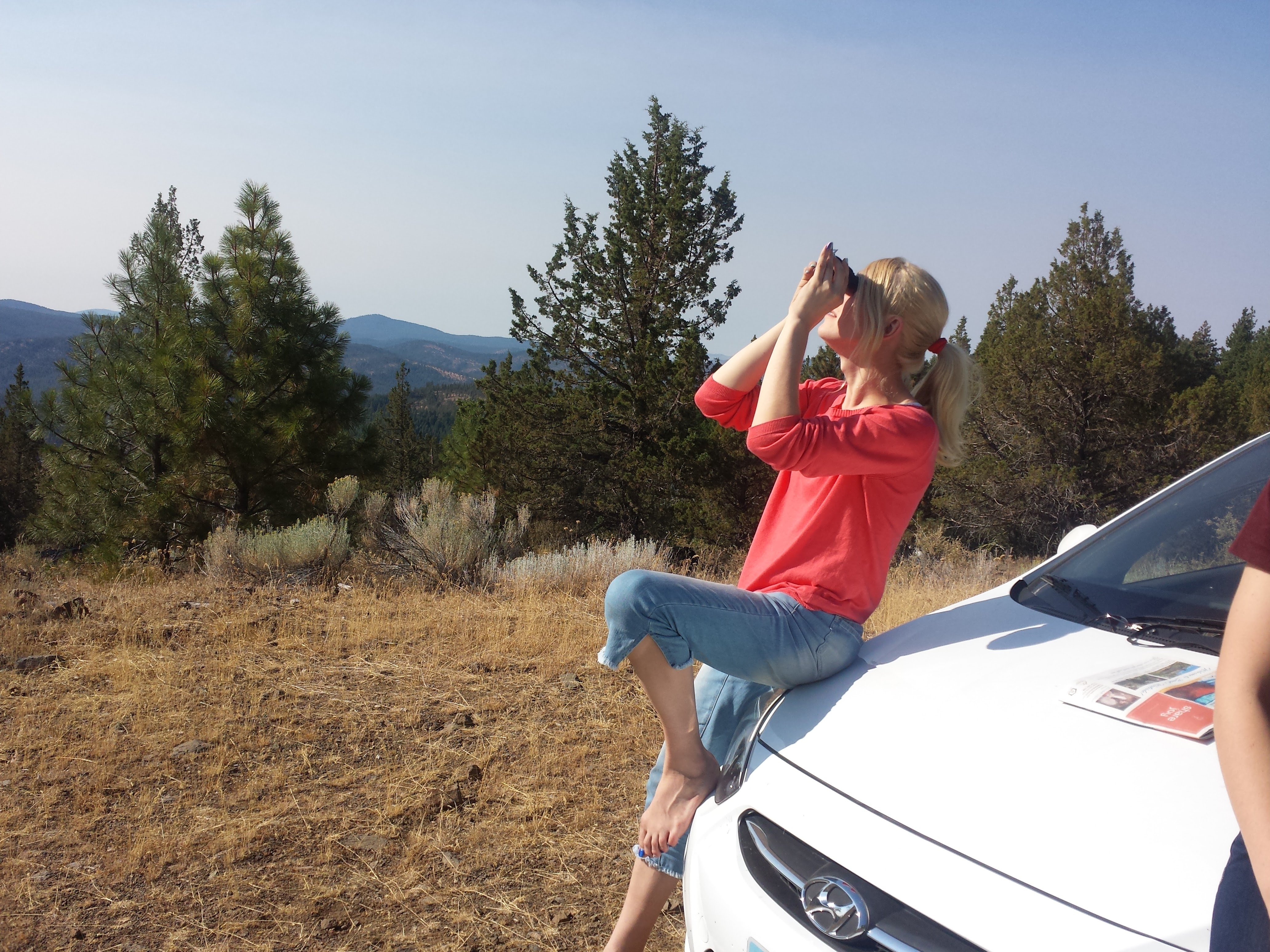 Me sitting on the hood of the pitiful rental car that was _definitely_ not meant to drive on completely un-maintained forest roads